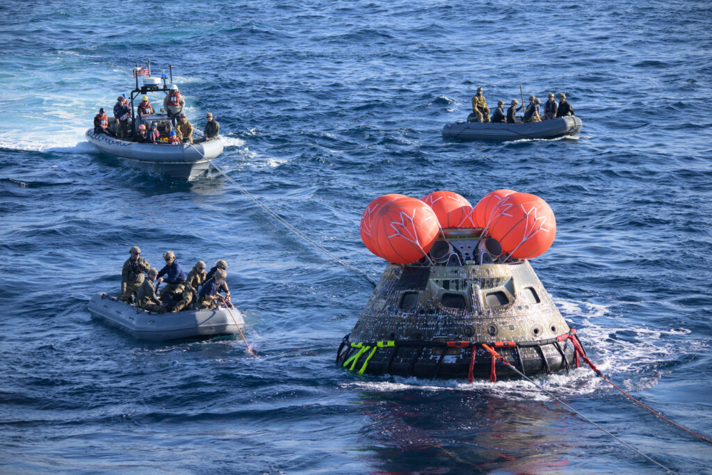 Space capsule recovery team after ocean landing
